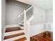 White wooden staircase and hardwood floors at 37525 Moore Dr, Dade City, FL 33525