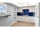 Kitchen with blue tile backsplash and white cabinets at 5108 Brittany S Dr # 506, St Petersburg, FL 33715