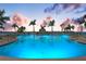 Inviting community pool at sunset, surrounded by palm trees at 5108 Brittany S Dr # 506, St Petersburg, FL 33715