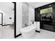 Contemporary bathroom featuring a soaking tub, modern fixtures, and stylish black and white tile accents at 6524 6Th N Ave, St Petersburg, FL 33710