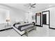 Bright bedroom featuring a sleek upholstered headboard, modern decor, and a bench, all with tile floors at 6524 6Th N Ave, St Petersburg, FL 33710