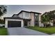 Two-story modern home with dark gray garage doors and stylish lighting at 6524 6Th N Ave, St Petersburg, FL 33710