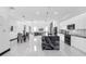 Open concept, featuring a modern kitchen with an expansive marble island and sleek white cabinetry at 6524 6Th N Ave, St Petersburg, FL 33710