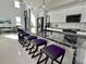 Kitchen features a marble waterfall island, modern bar stools, and stainless steel appliances at 6524 6Th N Ave, St Petersburg, FL 33710