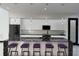 Modern kitchen with black granite countertops, bar stool seating, and stainless steel appliances at 6524 6Th N Ave, St Petersburg, FL 33710
