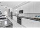 Modern kitchen features sleek white cabinetry, granite countertops, and stainless steel appliances at 6524 6Th N Ave, St Petersburg, FL 33710