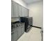 Modern laundry room with gray cabinets and black appliances at 6524 6Th N Ave, St Petersburg, FL 33710