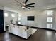 Modern living room featuring a large ceiling fan, dark floors, and contemporary decor at 6524 6Th N Ave, St Petersburg, FL 33710