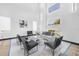 Airy living room with high ceilings, sleek modern furnishings, and many large sunny windows at 6524 6Th N Ave, St Petersburg, FL 33710