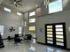 Open-concept living room with soaring ceilings, modern finishes, and lots of natural light at 6524 6Th N Ave, St Petersburg, FL 33710