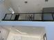 Second floor landing with modern railing, ceiling fan, and open view of living space below at 6524 6Th N Ave, St Petersburg, FL 33710