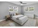 Well-lit bedroom with hardwood floors, light gray walls, ceiling fan, and windows providing natural light at 6602 S Emerson Ave, St Petersburg, FL 33707