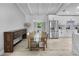 Dining room features hardwood floors, modern table setting, and a view into the updated kitchen at 6602 S Emerson Ave, St Petersburg, FL 33707