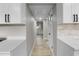 Hallway featuring hard wood floors, white molding, and access to rooms with natural light at 6602 S Emerson Ave, St Petersburg, FL 33707
