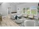 Spacious living room features high ceiling, hardwood floors, stylish furniture and plenty of natural light at 6602 S Emerson Ave, St Petersburg, FL 33707
