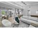 Open-concept living room features dining area, kitchen with marble island and hardwood floors at 6602 S Emerson Ave, St Petersburg, FL 33707