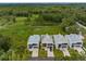 Modern, minimalist homes with flat roofs and sleek designs back onto a lush, green landscape at 7602 Antilla St, Tampa, FL 33625