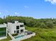 Aerial view of modern property featuring a pool, deck, and green space. This is a true oasis with complete privacy at 7602 Antilla St, Tampa, FL 33625