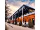 Exterior view of Armature Works with exposed beams and brick exterior with ample outdoor seating at 7602 Antilla St, Tampa, FL 33625