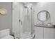 Modern bathroom highlighting a glass-enclosed shower with stylish tile work and contemporary fixtures, creating a clean aesthetic at 7602 Antilla St, Tampa, FL 33625