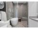 Modern bathroom boasts a glass-enclosed shower, soaking tub, and stylish tile flooring at 7602 Antilla St, Tampa, FL 33625