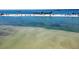 Beautiful coastal view showcases clear turquoise waters and sandy beach strip under a sunny sky at 7602 Antilla St, Tampa, FL 33625