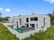 Modern home with a private pool and outdoor dining space, perfect for entertaining at 7602 Antilla St, Tampa, FL 33625