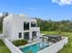 Stunning modern home featuring a pool and outdoor pergola seating area in a private backyard oasis at 7602 Antilla St, Tampa, FL 33625