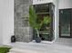 Modern home entrance with stone accent wall and contemporary landscaping at 7602 Antilla St, Tampa, FL 33625