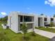 Modern home showcasing clean lines, a two-car garage, and manicured lawn at 7602 Antilla St, Tampa, FL 33625