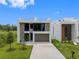 Modern two-story home with a gray accent wall and a two car garage at 7602 Antilla St, Tampa, FL 33625
