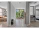Bright hallway with large windows overlooking lush greenery and access to bedrooms at 7602 Antilla St, Tampa, FL 33625