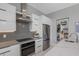 Modern kitchen with sleek white cabinets, stainless steel appliances, and marble countertops at 7602 Antilla St, Tampa, FL 33625