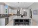 Modern kitchen with an island and pendant lighting, stainless steel appliances, and marble countertops at 7602 Antilla St, Tampa, FL 33625