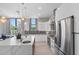 Contemporary kitchen with stainless steel appliances, large island, and pendant lighting at 7602 Antilla St, Tampa, FL 33625