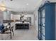 Spacious kitchen with modern appliances, large island with seating, and stylish chandelier at 7602 Antilla St, Tampa, FL 33625
