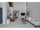 Bright living room with staircase, neutral tones, and view to entry way at 7602 Antilla St, Tampa, FL 33625