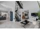 Bright living room with view to kitchen, staircase, and neutral furnishings at 7602 Antilla St, Tampa, FL 33625