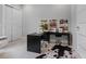 Bright office features a modern black desk, sewing machines, and ample storage space with a closet for organization at 7602 Antilla St, Tampa, FL 33625