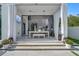 An outdoor dining area with a chandelier, curtains, and view of the interior at 7602 Antilla St, Tampa, FL 33625