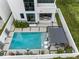 Aerial view of modern home featuring a pool, lounge chairs, and outdoor pergola seating area at 7602 Antilla St, Tampa, FL 33625