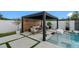 Relaxing outdoor space with modern pergola, seating area, and refreshing pool at 7602 Antilla St, Tampa, FL 33625