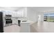 Modern kitchen with stainless steel appliances and white cabinets at 8077 Shore Lake Dr, Englewood, FL 34224