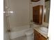 Bathroom with a shower/tub combo, vanity, and wood cabinet at 8510 Renald Blvd, Temple Terrace, FL 33637