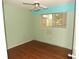 Bedroom with light green walls and wood-look flooring at 8510 Renald Blvd, Temple Terrace, FL 33637
