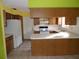 Wood kitchen cabinets, tile floor, and a white refrigerator at 8510 Renald Blvd, Temple Terrace, FL 33637
