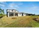 View of home's backyard showcasing a large grassy area at 8705 Coastal Key Way, Parrish, FL 34219