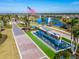 Community entrance with a scenic pond and American flag at 8705 Coastal Key Way, Parrish, FL 34219
