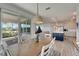 Dining area with wood table and view of kitchen and patio at 8705 Coastal Key Way, Parrish, FL 34219