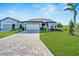Single-story home with a paved driveway and landscaped front yard at 8705 Coastal Key Way, Parrish, FL 34219